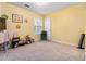 Bright bedroom with yellow walls, a window with blinds, and a simple chair and decorations at 3215 Rose Petal Ln, Powder Springs, GA 30127