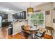 Bright breakfast nook with a round wood table and natural lighting by large window at 3215 Rose Petal Ln, Powder Springs, GA 30127