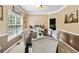 Elegant dining room with wainscoting, neutral tones, and stylish furnishings for formal gatherings at 3215 Rose Petal Ln, Powder Springs, GA 30127