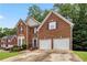 Charming brick home featuring a two-car garage and well-maintained landscaping at 3215 Rose Petal Ln, Powder Springs, GA 30127