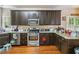 Well-equipped kitchen with stainless steel appliances, granite countertops, and ample cabinet space at 3215 Rose Petal Ln, Powder Springs, GA 30127