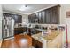 Spacious kitchen with granite counters, stainless steel appliances and dark wood cabinets at 3215 Rose Petal Ln, Powder Springs, GA 30127