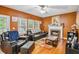 Cozy living room with a fireplace, dark furniture, and windows offering plenty of natural light at 3215 Rose Petal Ln, Powder Springs, GA 30127