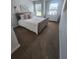 A light and airy bedroom with a plush bed, soft decor, and large windows overlooking the landscape at 4827 Station Lane -Lot 31, Union City, GA 30349