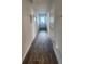 A long, well-lit hallway with modern flooring and crisp white trim, leading to various rooms at 4827 Station Lane -Lot 31, Union City, GA 30349