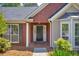 Inviting front porch with brick accents, decorative columns, and a stylish door, enhancing the home's curb appeal at 5630 Tallantworth Xing, Cumming, GA 30040