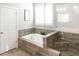 Bathroom with tub and shower combo plus attractive tile work at 1976 Boyd Trace Nw Ln, Atlanta, GA 30318
