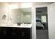 The bathroom has double sinks, a black vanity and a view of the bedroom at 1976 Boyd Trace Nw Ln, Atlanta, GA 30318