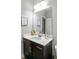 Contemporary bathroom featuring a dark vanity with a white countertop and a large mirror at 1976 Boyd Trace Nw Ln, Atlanta, GA 30318