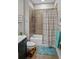 Tiled bathroom with a shower-tub combination, toilet, and modern vanity; a functional space at 1976 Boyd Trace Nw Ln, Atlanta, GA 30318