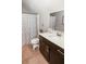 Compact bathroom with a shower-tub combination, dark vanity, and a neutral color palette at 1976 Boyd Trace Nw Ln, Atlanta, GA 30318