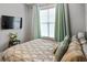 This bedroom has a mounted TV and a large window at 1976 Boyd Trace Nw Ln, Atlanta, GA 30318
