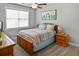 Comfortable bedroom with carpet, a ceiling fan, and a large window at 1976 Boyd Trace Nw Ln, Atlanta, GA 30318