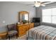 Comfortable bedroom featuring a wooden dresser, chair, and ceiling fan for added comfort at 1976 Boyd Trace Nw Ln, Atlanta, GA 30318