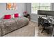 Cozy bedroom with plush blankets, bright artwork, and a dedicated workspace with a modern desk at 1976 Boyd Trace Nw Ln, Atlanta, GA 30318