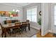Dining room with a large window, stylish chandelier, and a wooden table with seating for six at 1976 Boyd Trace Nw Ln, Atlanta, GA 30318