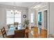 Elegant dining room featuring a modern chandelier, large windows, and hardwood floors at 1976 Boyd Trace Nw Ln, Atlanta, GA 30318