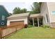 Charming home with a fenced yard and covered patio located next to the detached garage at 1976 Boyd Trace Nw Ln, Atlanta, GA 30318