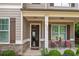 Inviting home entrance featuring a covered porch and well-manicured landscaping at 1976 Boyd Trace Nw Ln, Atlanta, GA 30318