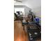 Bright home gym with hardwood floors, weights, weight bench, exercise machines and workspace at 1976 Boyd Trace Nw Ln, Atlanta, GA 30318