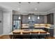 Modern kitchen with stainless steel appliances, dark cabinets, and a spacious island with seating at 1976 Boyd Trace Nw Ln, Atlanta, GA 30318