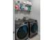 A laundry room with a washer and dryer and storage shelves at 1976 Boyd Trace Nw Ln, Atlanta, GA 30318