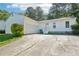 A white, one-story home featuring an attached garage and a long driveway at 2058 Corners Cir, Lithonia, GA 30058
