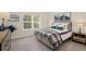 Cozy bedroom with natural light, stylish decor, including framed art and bedside lamps at 1129 Georgian Point Dr, Lawrenceville, GA 30045