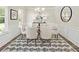 Bright dining room features a modern chandelier, wainscoting and stylish black and white rug at 1129 Georgian Point Dr, Lawrenceville, GA 30045