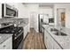 The kitchen features stainless steel appliances and a kitchen island with a sink at 1129 Georgian Point Dr, Lawrenceville, GA 30045