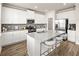 Bright kitchen has stainless steel appliances, a center island and a grey backsplash at 1129 Georgian Point Dr, Lawrenceville, GA 30045