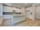 Kitchen features an island, modern lighting, and stylish white cabinetry at 1129 Georgian Point Dr, Lawrenceville, GA 30045
