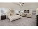 Spacious main bedroom with vaulted ceiling, large windows, sitting area and neutral color palette at 1129 Georgian Point Dr, Lawrenceville, GA 30045