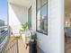 A cozy balcony features a seating area with an outdoor sofa, a small table, and views at 1274 Longreen Terrace # 113, Atlanta, GA 30318