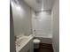 Bathroom with a vanity sink, toilet and tub featuring white subway tile at 1274 Longreen Terrace # 113, Atlanta, GA 30318