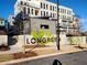 An exterior view of the community sign with the building in the background at 1274 Longreen Terrace # 113, Atlanta, GA 30318