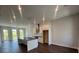 Living room with an open concept design into the kitchen and featuring hardwood floors throughout at 1274 Longreen Terrace # 113, Atlanta, GA 30318