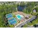 Aerial view of neighborhood amenities, including a pool, tennis courts, and playground by a lake at 1641 Rocky Knoll Ln, Dacula, GA 30019