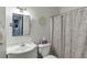 Bathroom with a vanity, a decorative mirror, and patterned shower curtain at 1641 Rocky Knoll Ln, Dacula, GA 30019
