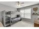 bedroom with gray bunk beds, carpet flooring, a ceiling fan, and a window at 1641 Rocky Knoll Ln, Dacula, GA 30019