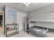 bedroom featuring gray bunk beds, a ceiling fan, and neutral decor, creating a cozy space at 1641 Rocky Knoll Ln, Dacula, GA 30019