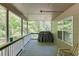 Relaxing covered deck with a grill, offering a serene view of the surrounding trees at 1641 Rocky Knoll Ln, Dacula, GA 30019