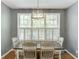 The dining area is illuminated by a modern light fixture and offers natural light from a large window at 1641 Rocky Knoll Ln, Dacula, GA 30019