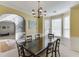 Bright dining room with large table, chandelier, and an open layout to the living room at 1641 Rocky Knoll Ln, Dacula, GA 30019
