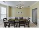 Elegant dining room with bay window, modern chandelier, and chair rail detail at 1641 Rocky Knoll Ln, Dacula, GA 30019