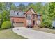 Beautiful brick home with well-manicured lawn, basketball hoop, and attached two car garage at 1641 Rocky Knoll Ln, Dacula, GA 30019