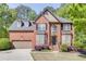 Charming brick home with meticulously landscaped front yard and classic architectural details at 1641 Rocky Knoll Ln, Dacula, GA 30019