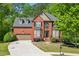 Beautiful two-story brick home with a manicured lawn and a spacious driveway at 1641 Rocky Knoll Ln, Dacula, GA 30019