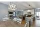 An open-concept kitchen features stainless appliances, an island with granite countertop, and flows into the living room at 1641 Rocky Knoll Ln, Dacula, GA 30019