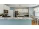Well-lit kitchen featuring white cabinets, granite countertops, stainless steel appliances, and breakfast bar at 1641 Rocky Knoll Ln, Dacula, GA 30019